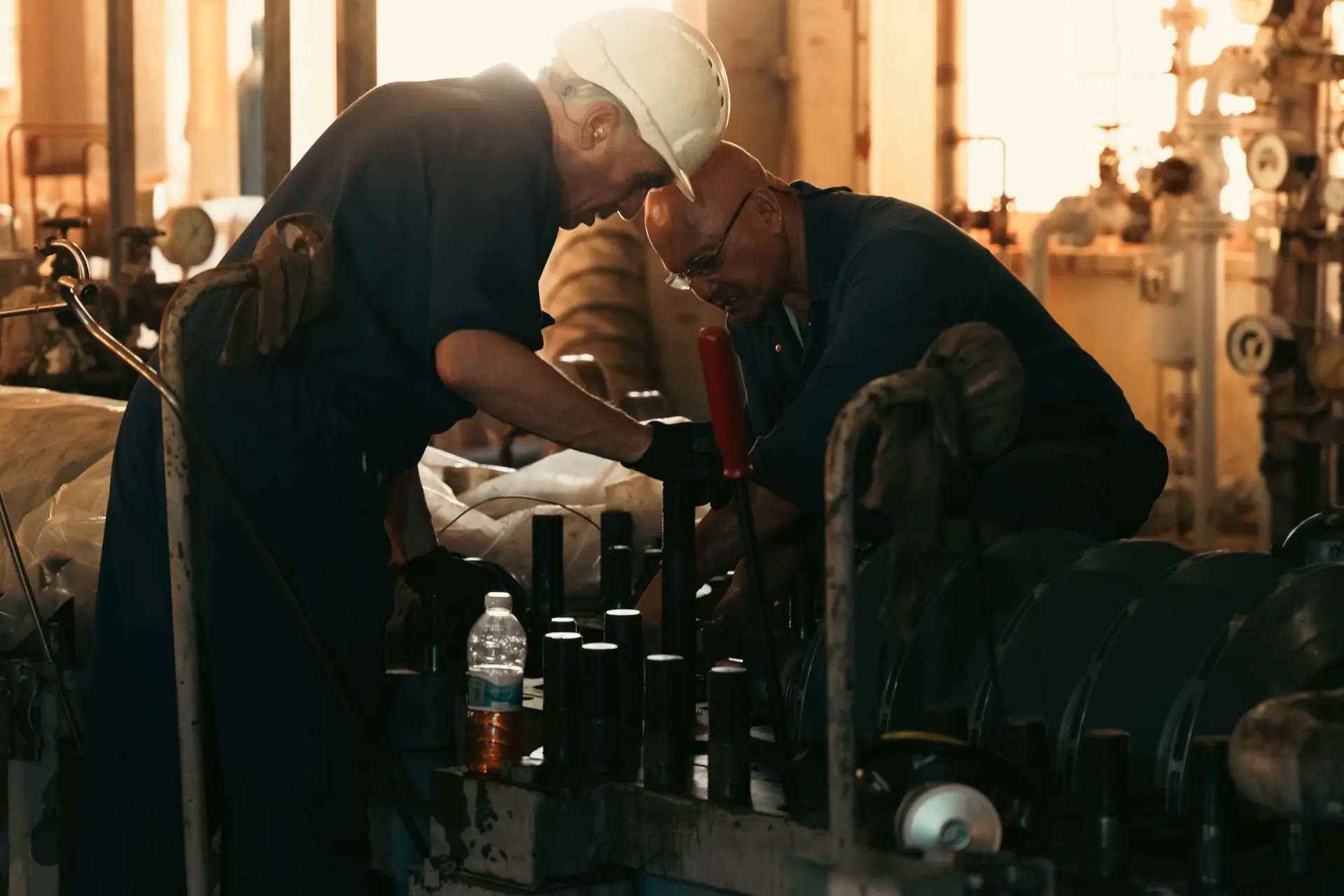 Technicians working on plant pipework